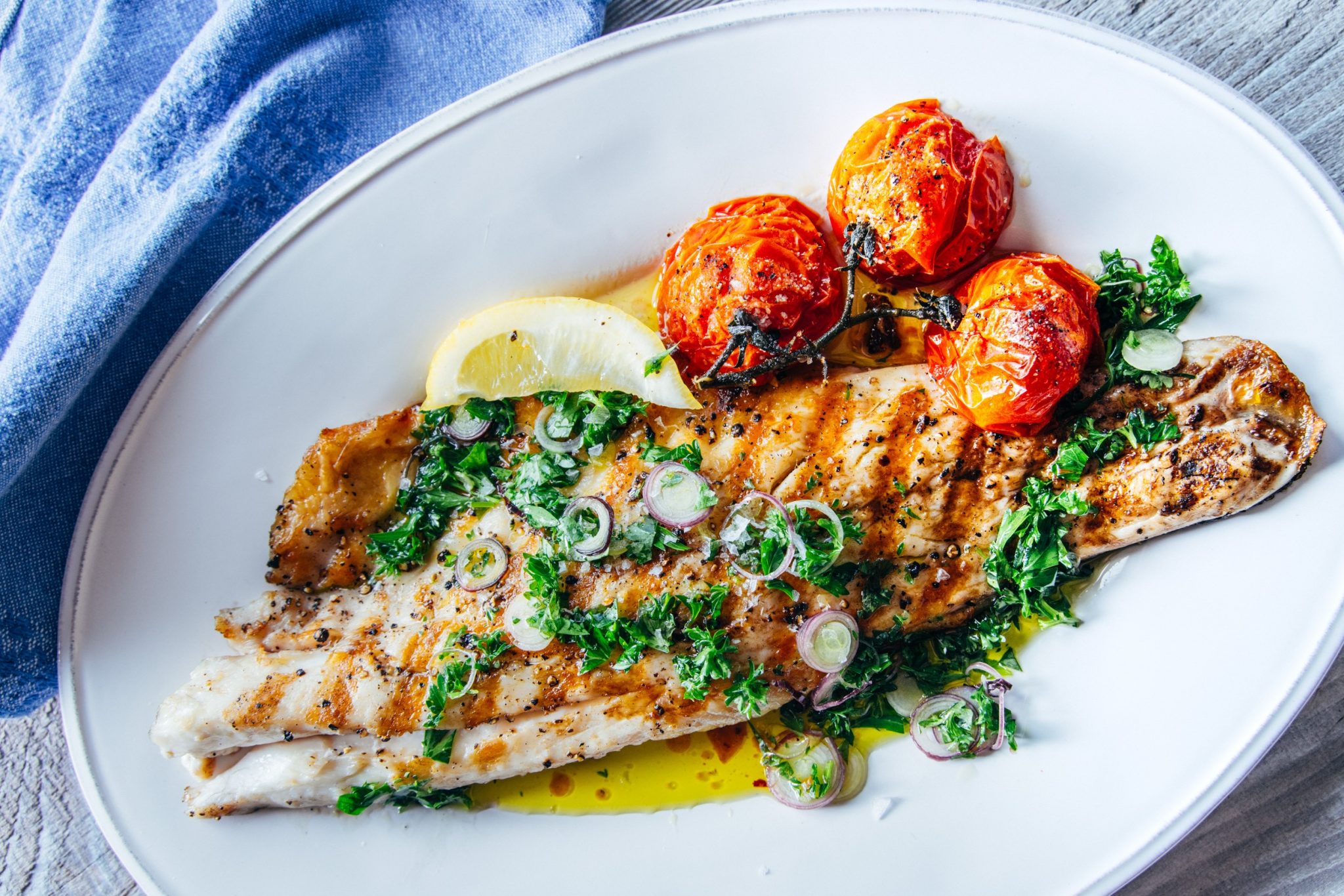 Roasted Pacifico Striped Bass with Baja Chimichurri and Blistered Tomatoes  - Santa Monica Seafood Market & Restaurant