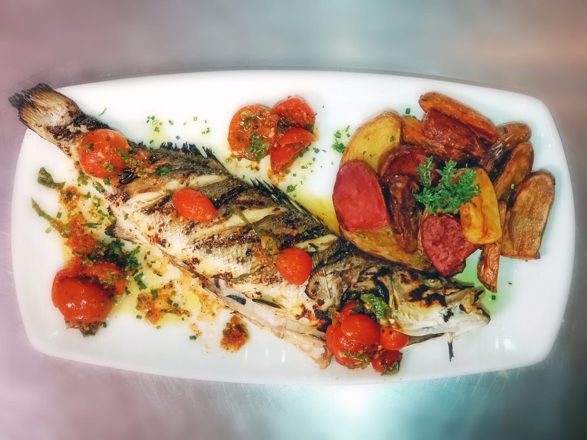 Whole Roasted European Seabass with Herb Potatoes and Basil Tomatoes